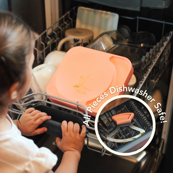 Overhead view of child placing all Totchop components in dishwasher